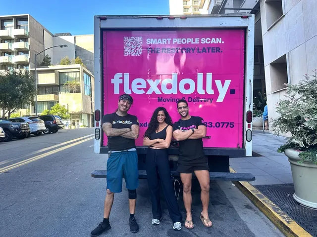 Three Flexdolly team members in front of the truck's pink rear door