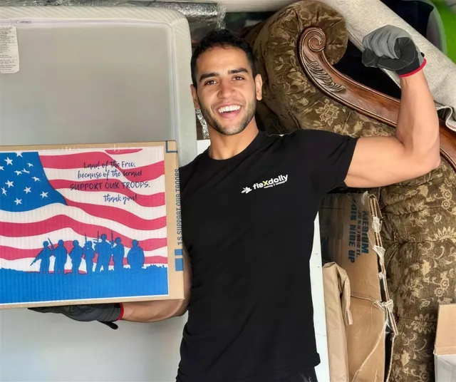 Flexdolly crew member with the veteran flag on the truck