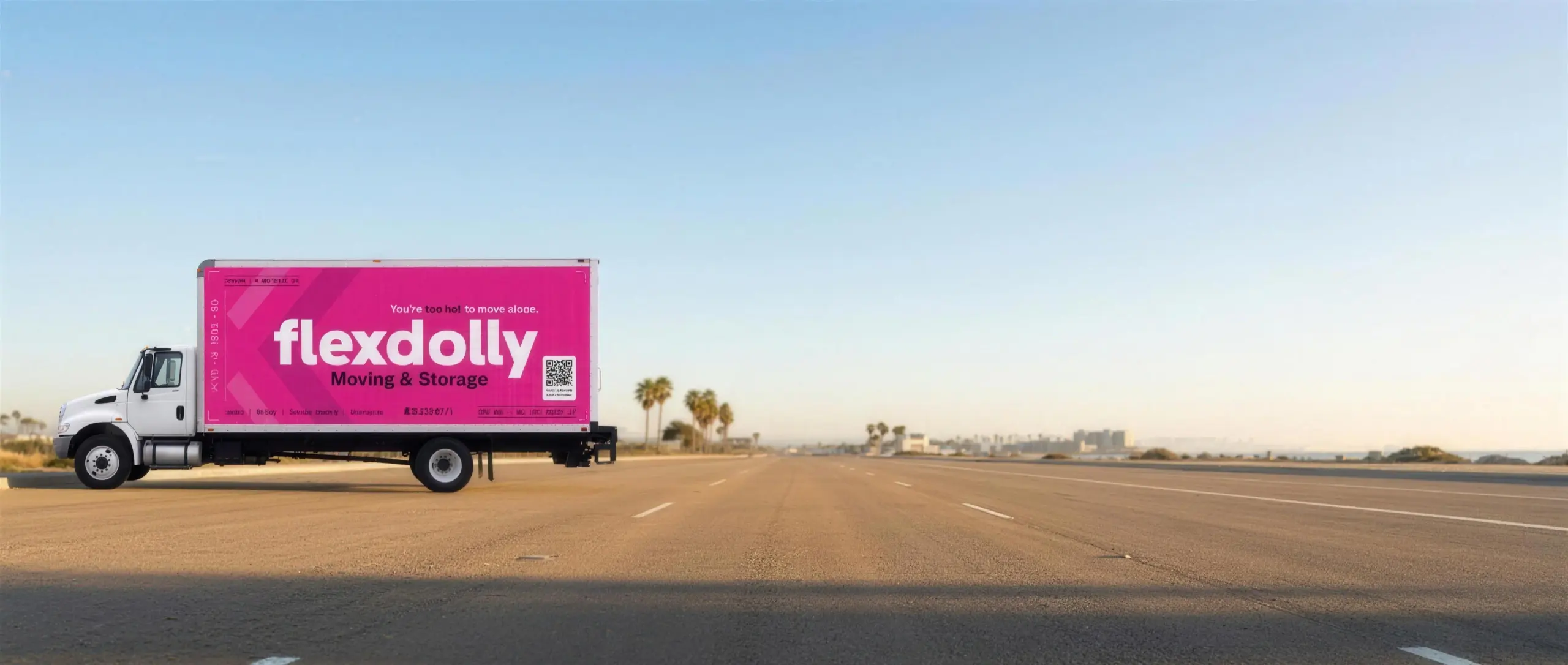 A hot-pink Flexdolly box truck in the new livery on a sunlit San Diego street