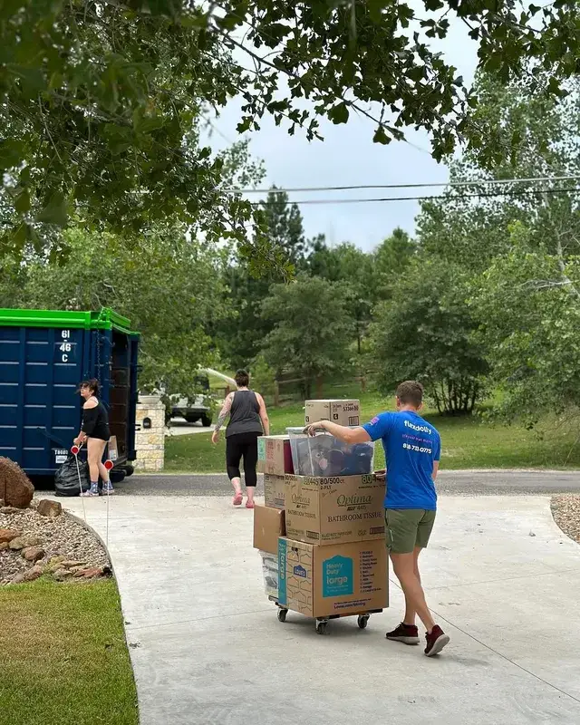 Flexdolly mover rolling a stacked box cart up a driveway