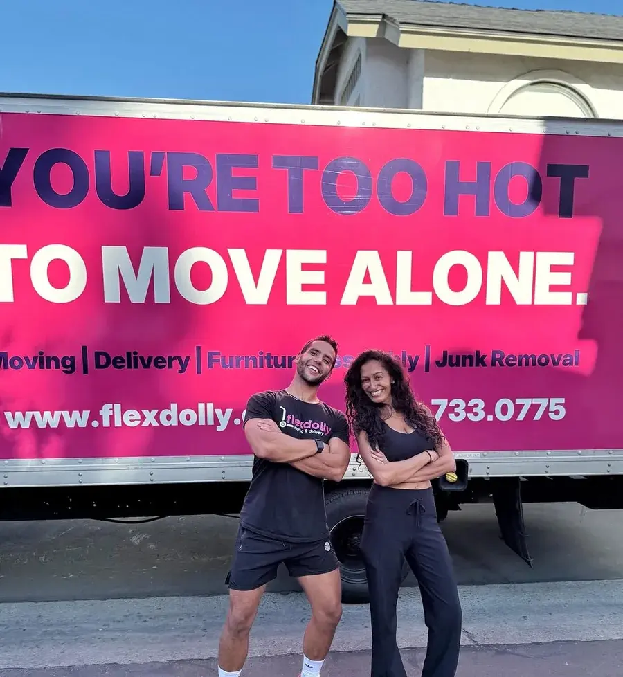 Two Flexdolly team members in front of the slogan truck