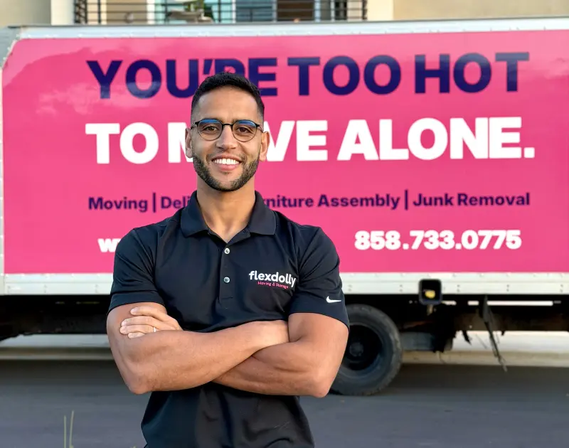 Nas in a Flexdolly polo in front of the hot pink livery truck